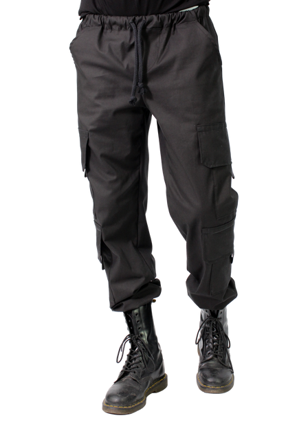 BLACK cargo pants worn with black boots on a white background