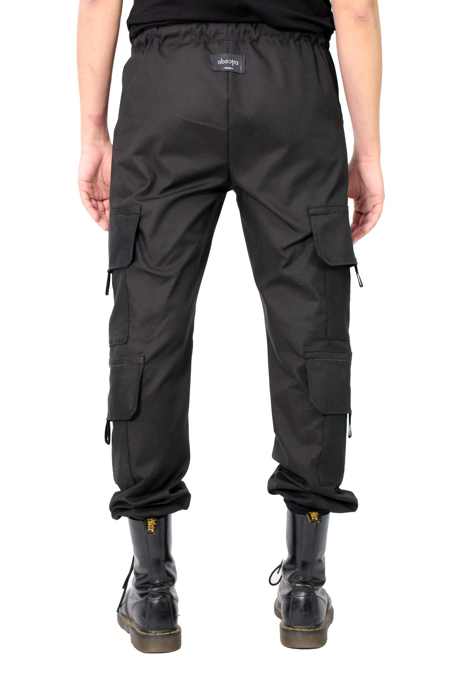 Person wearing black cargo pants on a white background