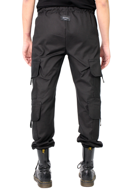 Person wearing black cargo pants on a white background